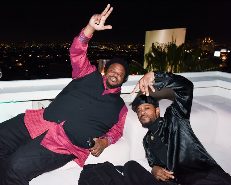 Craig Robinson and Lakeith Stanfield sitting and posing at W Magazine’s Best Performances Party