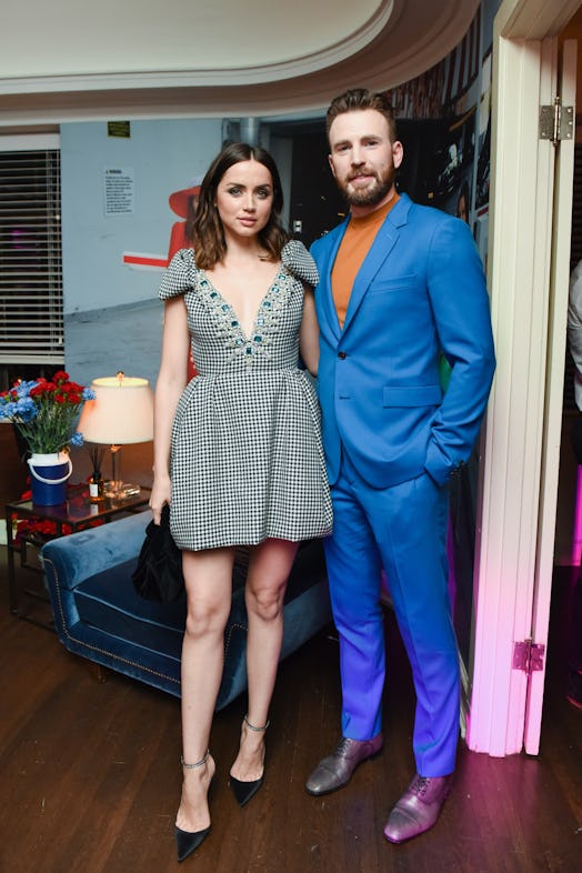 Ana De Armas and Chris Evans standing and posing at W Magazine’s Best Performances Party