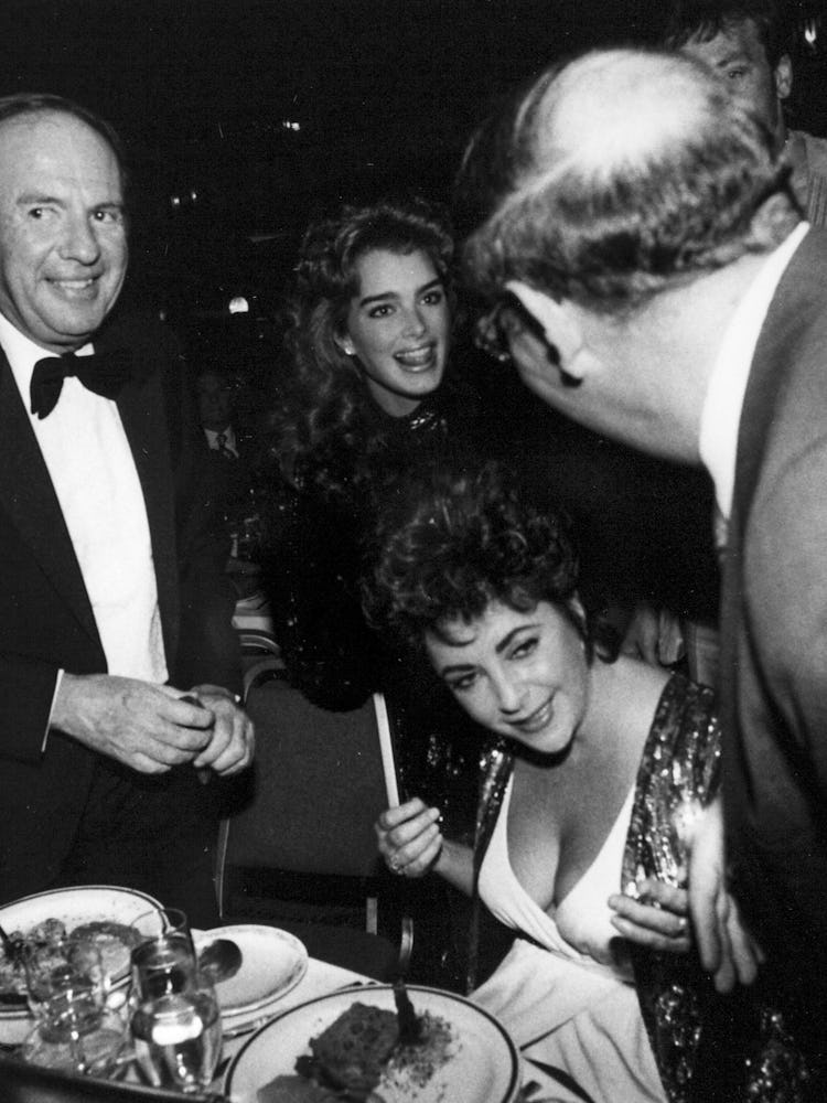 Elizabeth Taylor, Brooke Shields, and Victor Luna together during New Year’s Eve at the Hilton Hotel...