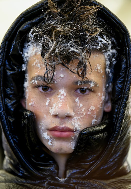 Closeup of a boy face with snow
