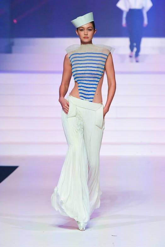 Gigi Hadid in a blue-white striped top, white pants and hat during Jean Paul Gaultier's Last Couture...
