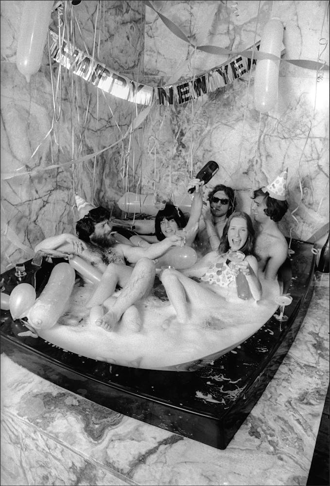 Group of girls lying together in an oversized bathtub