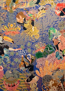 A large artwork piece by Raqib Shaw with floral elements and flowers.