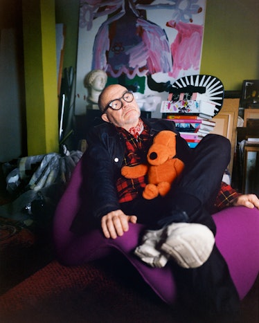  Christian Lacroix lying with a stuffed dog on his lap 