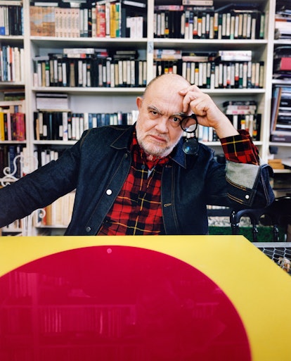 Christian Lacroix posing in a library
