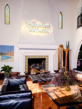The living room, with a beaded-curtain artwork by Kori Newkirk in Bettina Korek's Los Feliz home