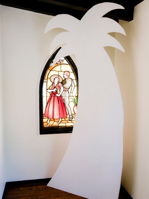 Sam Davis piece and one of the house’s original stained-glass windows in Bettina Korek's Los Feliz h...