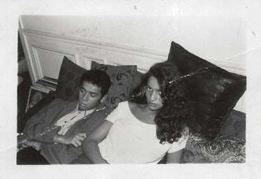 An old photograph with Christian Louboutin and Farida Khelfa lying on a couch