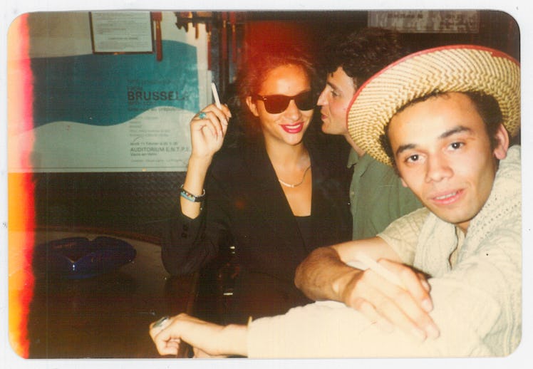 An old photograph with Christian Louboutin in a straw hat and Farida Khelfa