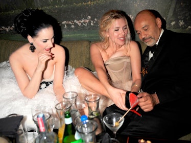 Christian Loboutin, Dita Von Teese, and Scarlett Johansson sitting and laughing
