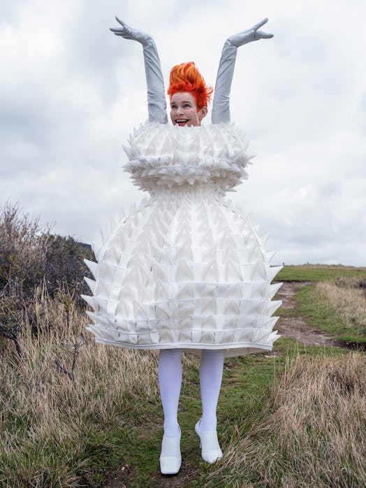  Sandy Powell posing while wearing a Noir Kei Ninomiya dress, Urstadt Swan gloves, Falke tights, and...