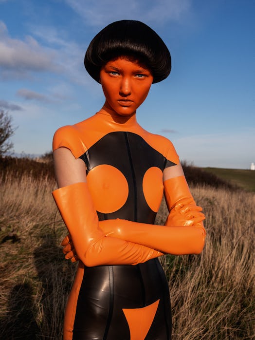 A female model wearing an orange costume for the film How to Talk to Girls at Parties
