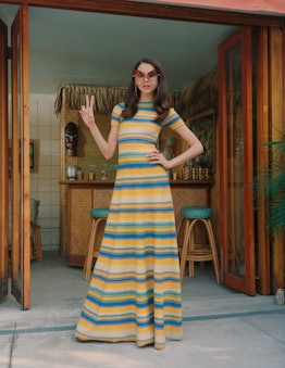 Margaret Qualley posing in a striped Marc Jacobs dress and sunglasses