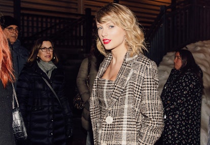 Taylor Swift in a plaid beige coat and matching dress 