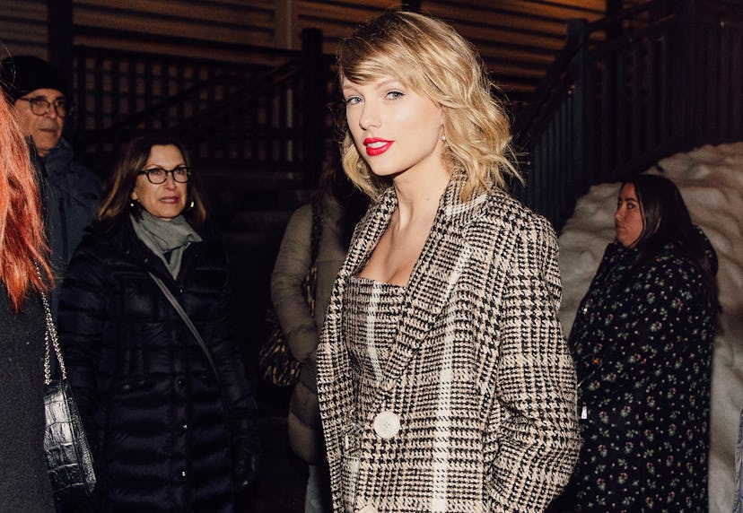 Taylor Swift in a plaid beige coat and matching dress