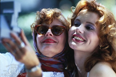 Susan Sarandon and Geena Davis taking a selfie with a photo camera while smiling