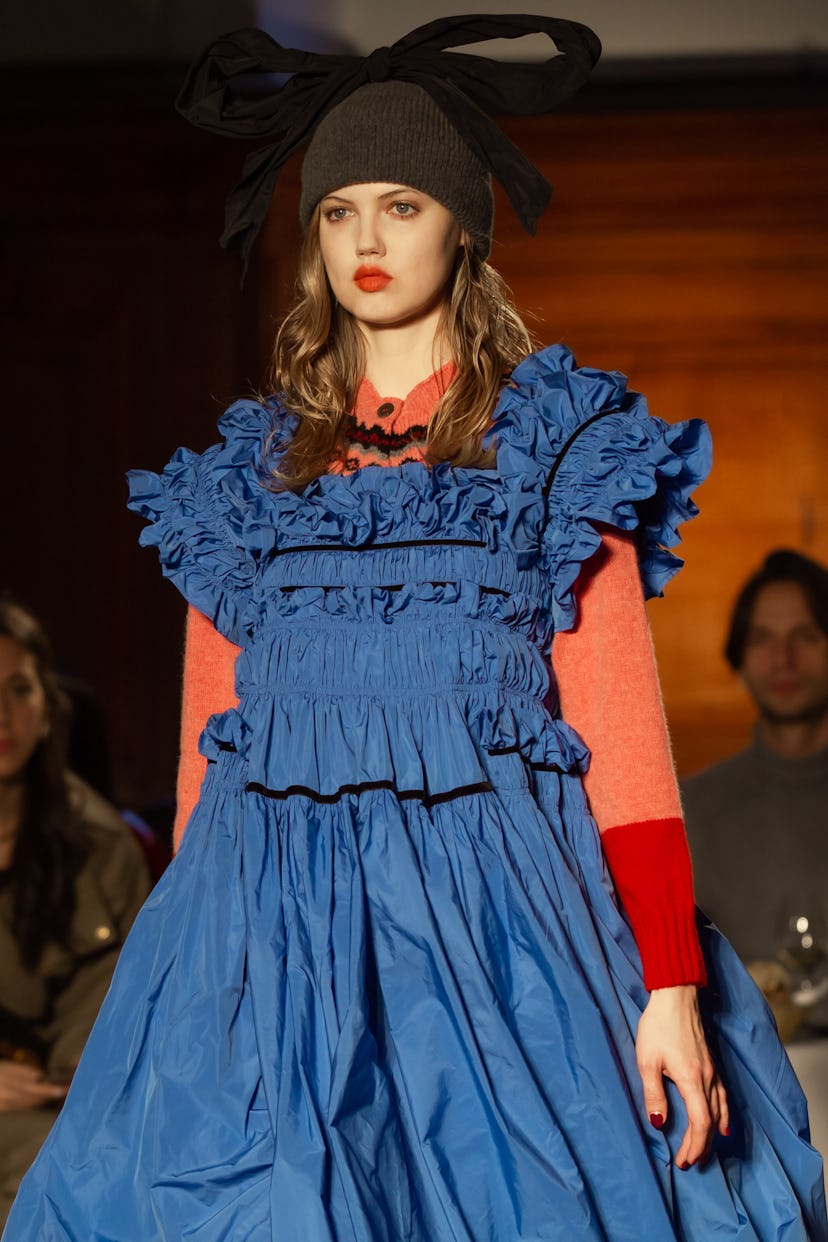 Lindsey Wixson wearing a blue tulle dress with orange sleeves by Molly Godard