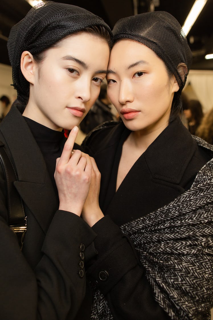 Two models in black outfits posing next to each other at Balmain Fall 2020