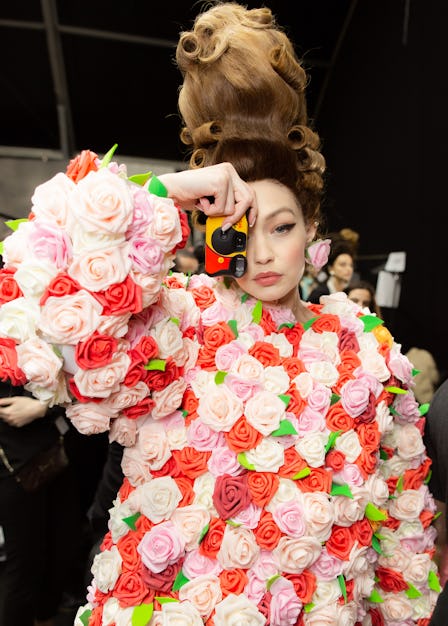 Gigi Hadid in a rose 3D print outfit at Moschino Fall 2020: Backstage with a disposable camera