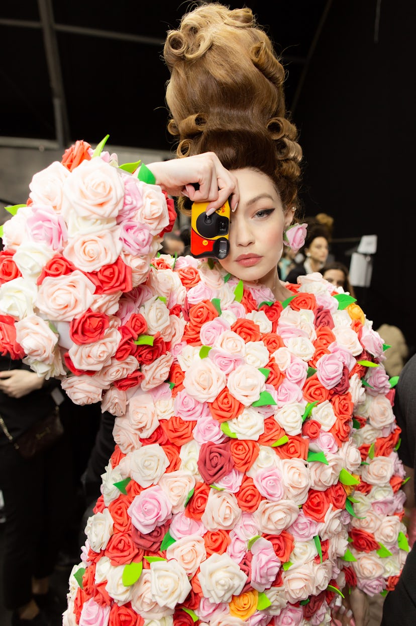 Gigi Hadid in a rose 3D print outfit at Moschino Fall 2020: Backstage with a disposable camera