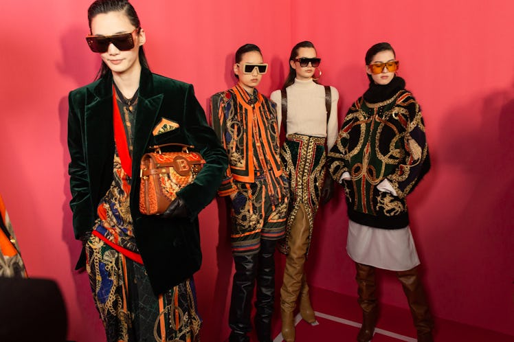 Four models in multi-colored outfits backstage at Balmain Fall 2020