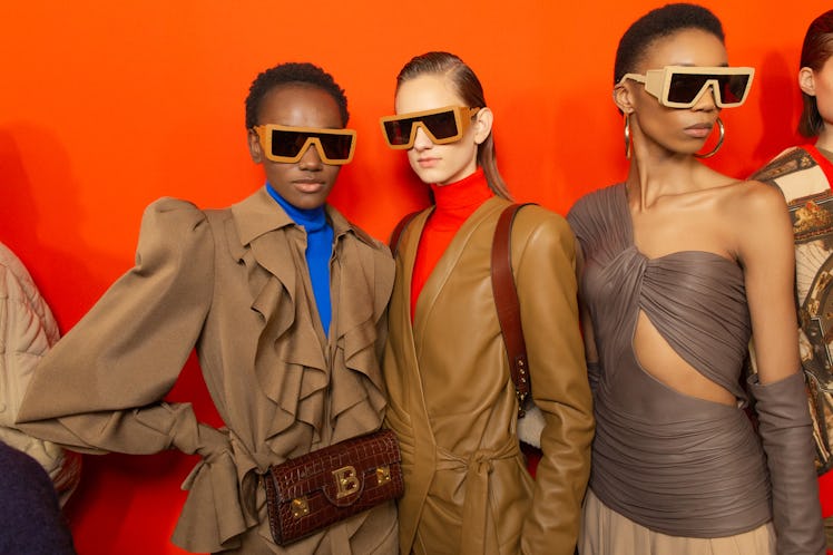 Three models in brown outfits at Balmain Fall 2020
