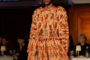 A model wearing a beige-red floral dress at Molly Goddard’s London Fashion Week Show