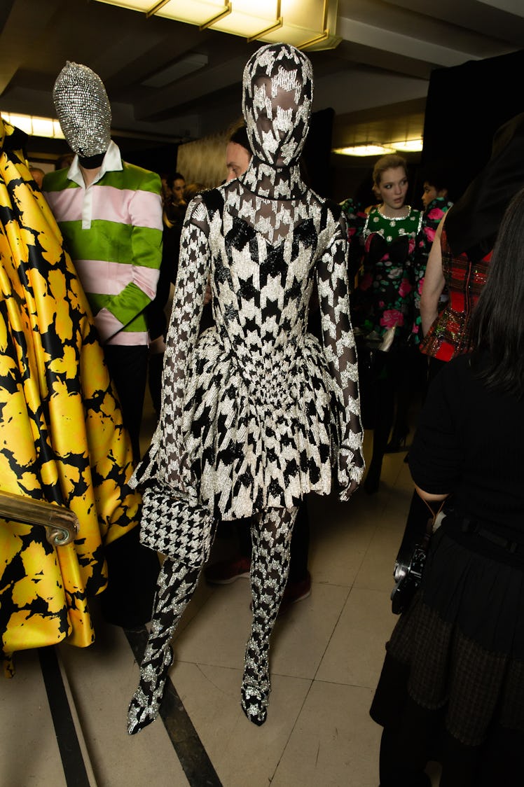 A model wearing a black-and white outfit that fully covers her body and face at Richard Quinn‘s fall...