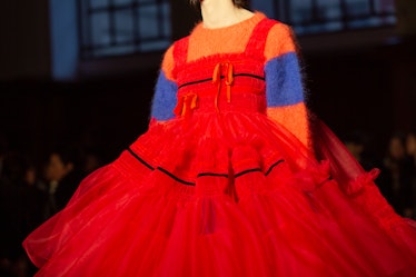 A model wearing an orange-blue sweater and a red tulle dress at Molly Goddard’s London Fashion Week ...