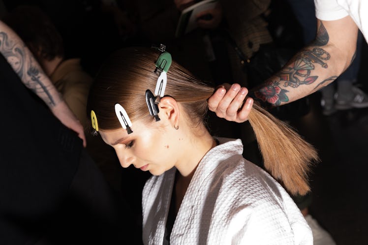 Model getting her hair done in backstage at the Tom Ford Fall 2020 fashion show