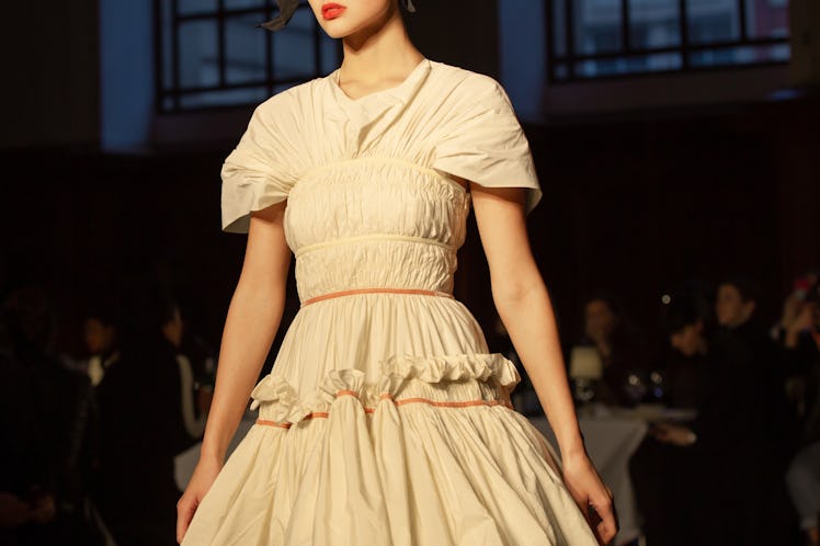 A model wearing a beige frill dress at Molly Goddard’s London Fashion Week Show