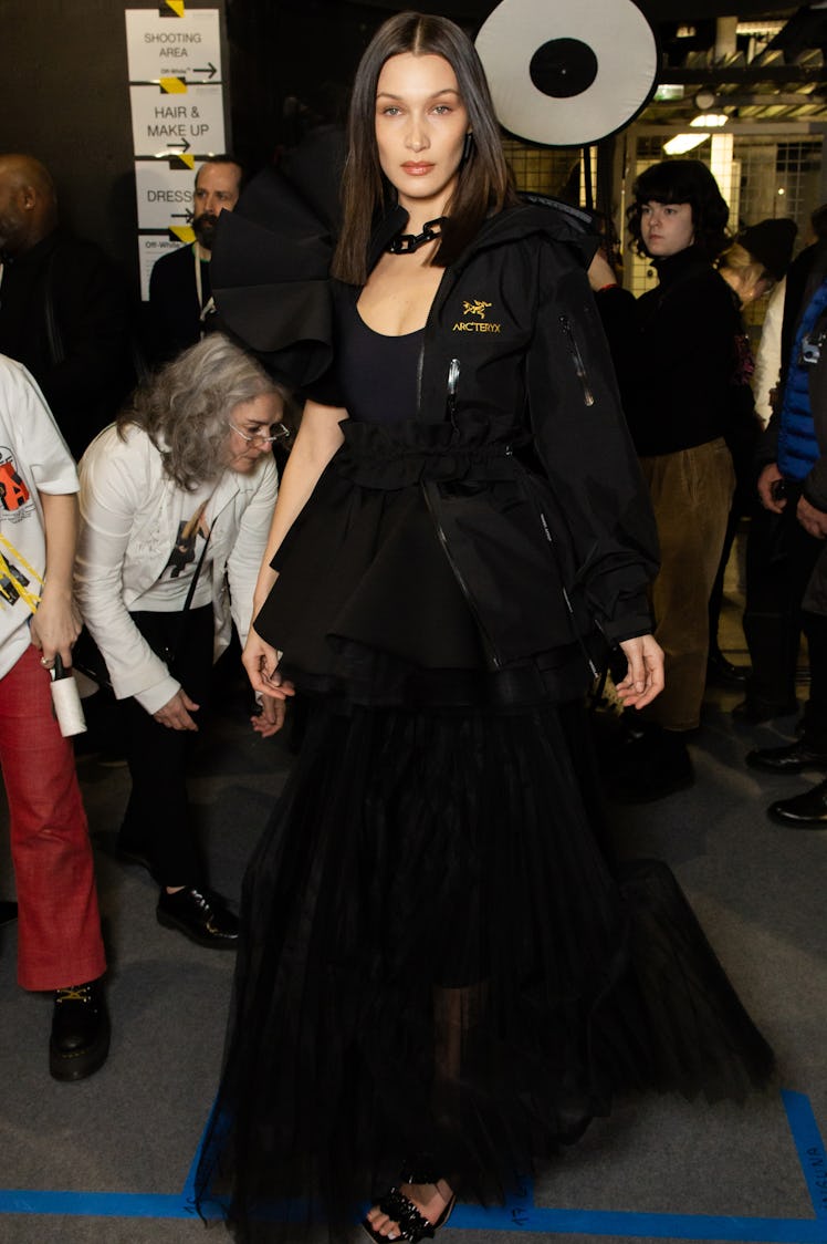 Bella Hadid in a black tulle dress and a black jacket backstage at Off-White