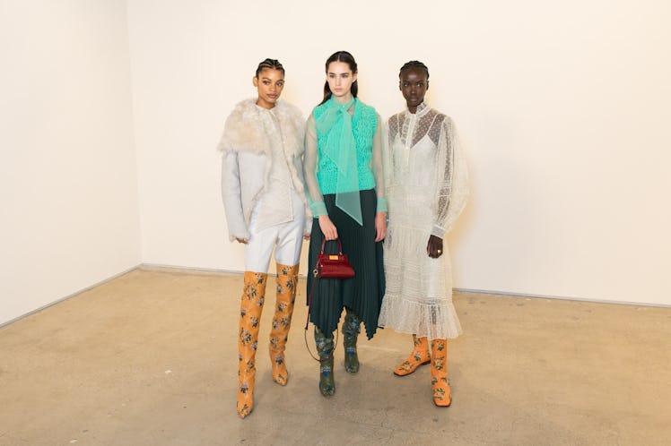 Three models posing for a photo at the Tory Burch FW20 during New York Fashion Week