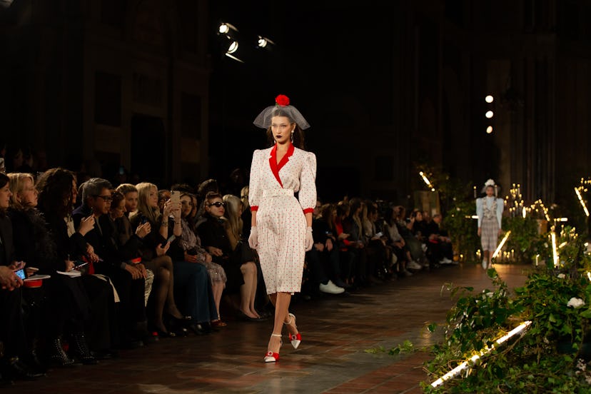 Bella Hadid walking in a white-red dress at the Rodarte NYFW Show