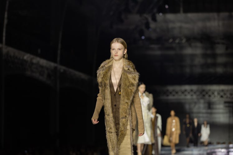 A model wearing a brown dress and a beige fur coat at the Burberry Fall 2020 show