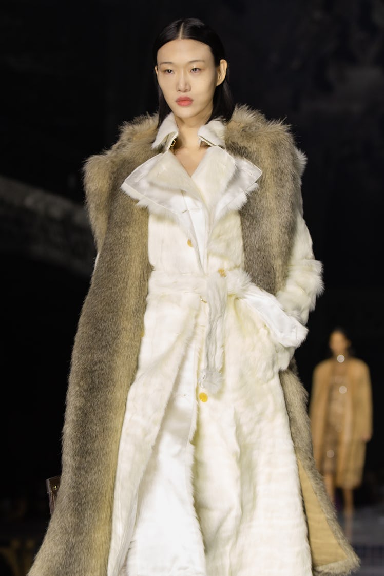 A model wearing a white fur coat and brown fur vest at the Burberry Fall 2020 show