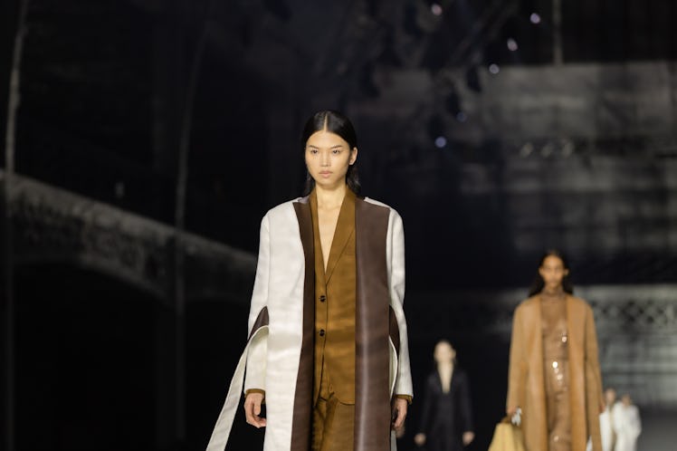 A model wearing a brown suit and a brown-white coat at the Burberry Fall 2020 show