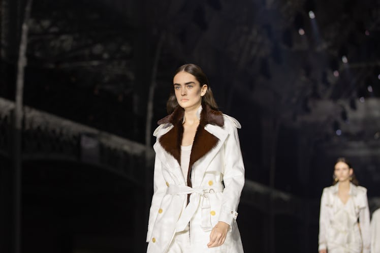 A model wearing a white suit with a brown collar at the Burberry Fall 2020 show