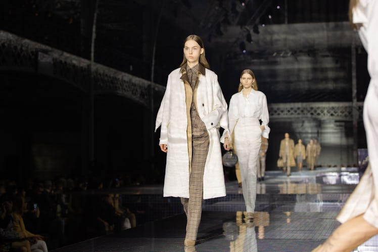 A model wearing a brown suit and a white coat at the Burberry Fall 2020 show