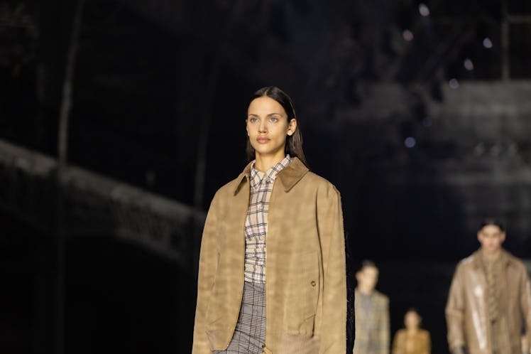 A model wearing a beige checked shirt, grey trousers and a brown jacket at the Burberry Fall 2020 sh...