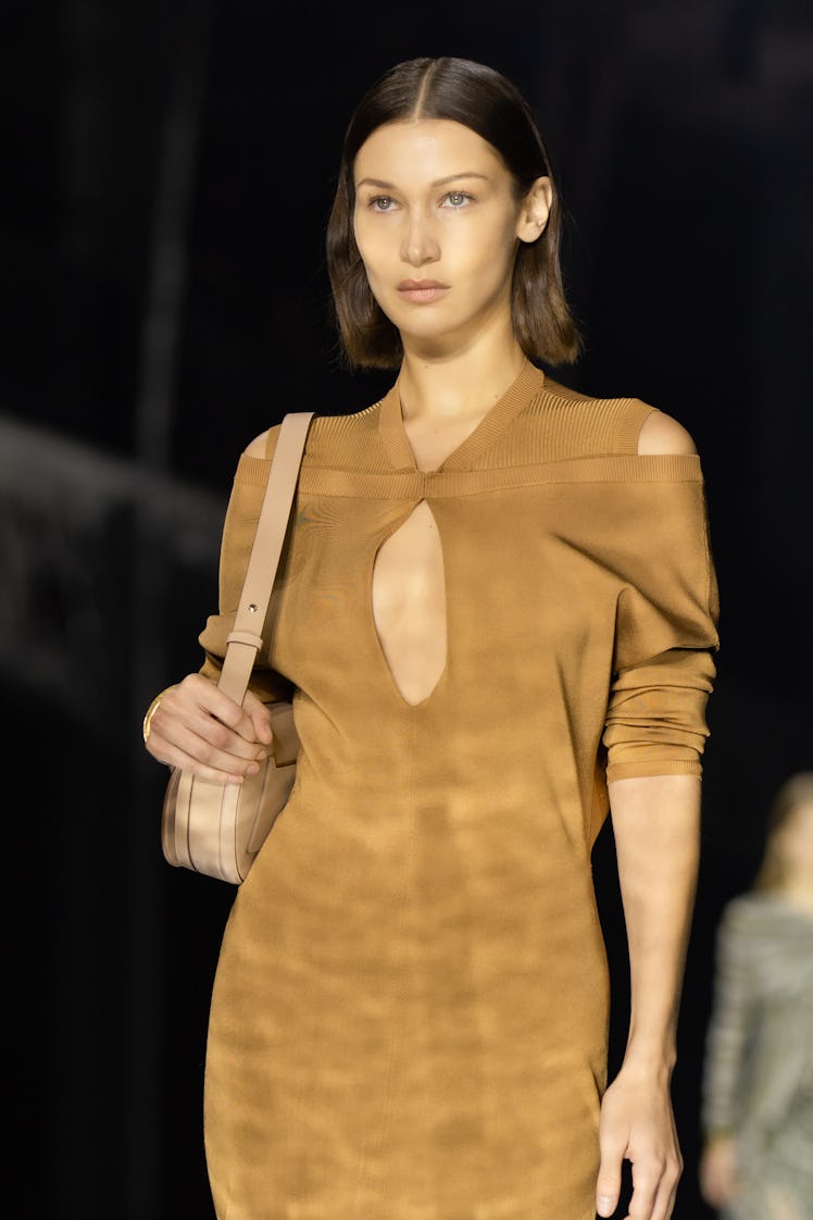Bella Hadid wearing a brown dress and a beige bag at the Burberry Fall 2020 show