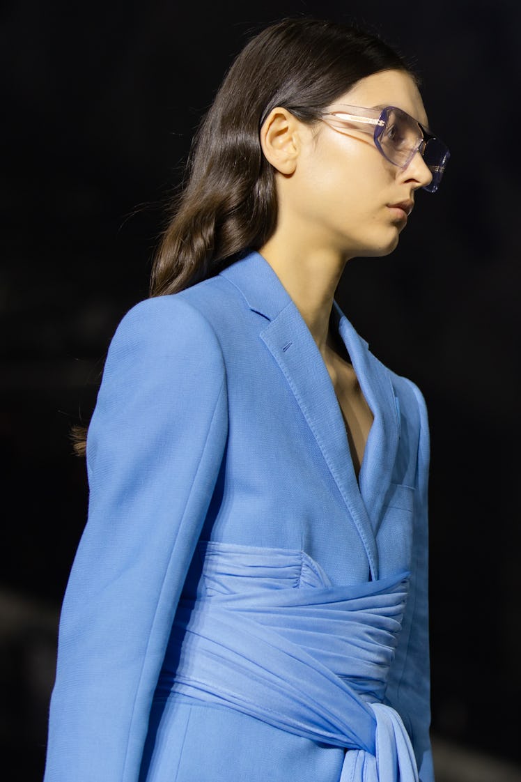 A model wearing a blue suit with a tulle belt and sunglasses at the Burberry Fall 2020 show