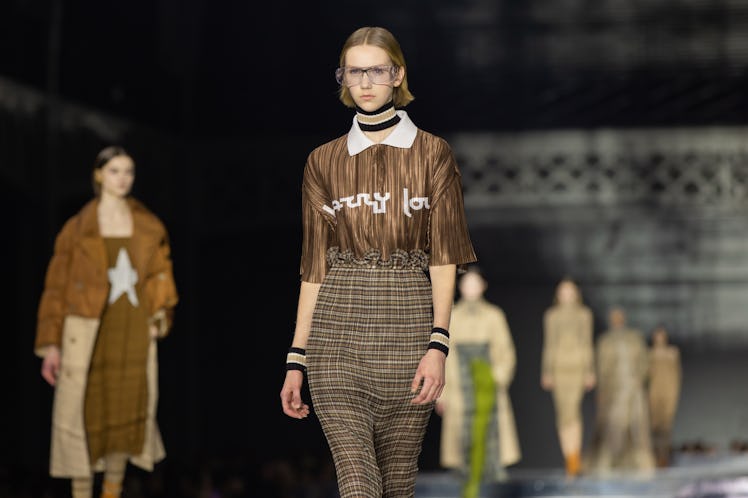 A model wearing a brown-white shirt and a brown skirt at the Burberry Fall 2020 show