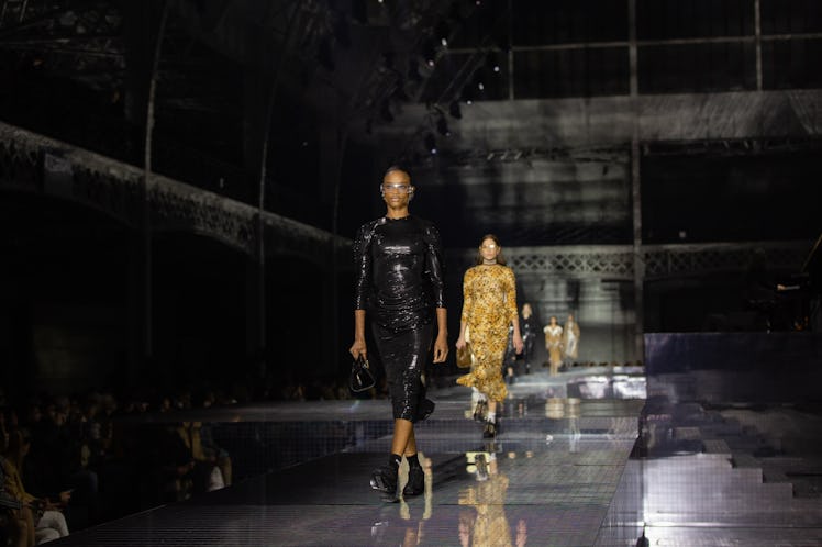 A model in a black dress and a model in a yellow dress at the Burberry Fall 2020 show