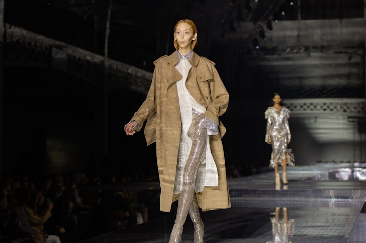 A model in a white dress and a brown coat at the Burberry Fall 2020 show