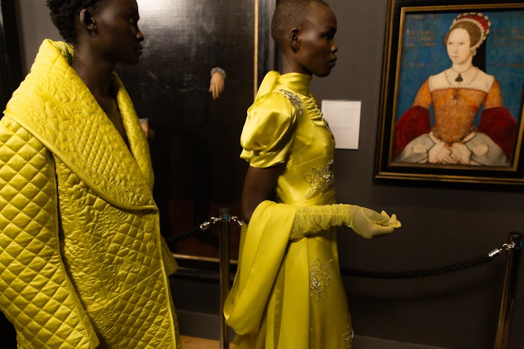 Two models in bright yellow outfits in backstage at the Erdem fall 2020 show