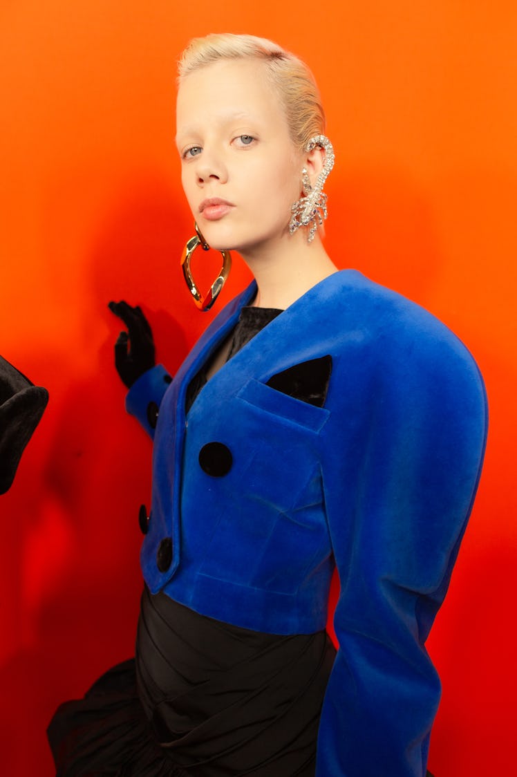 A model in a black/blue blazer backstage at Balmain Fall 2020