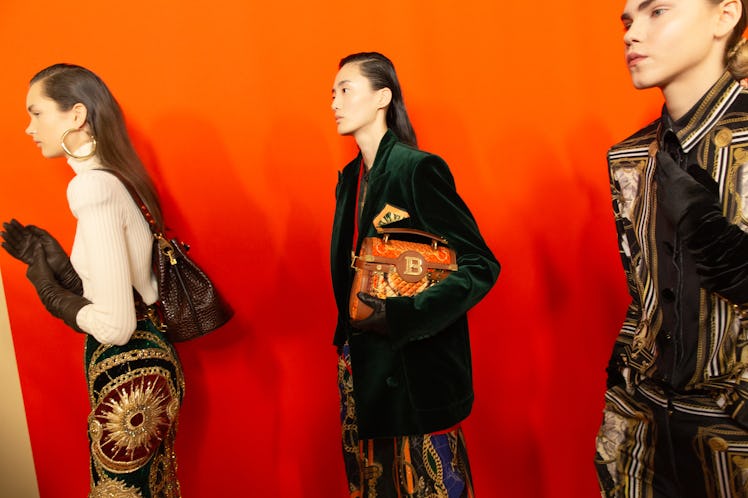 Three models standing in line backstage at Balmain Fall 2020