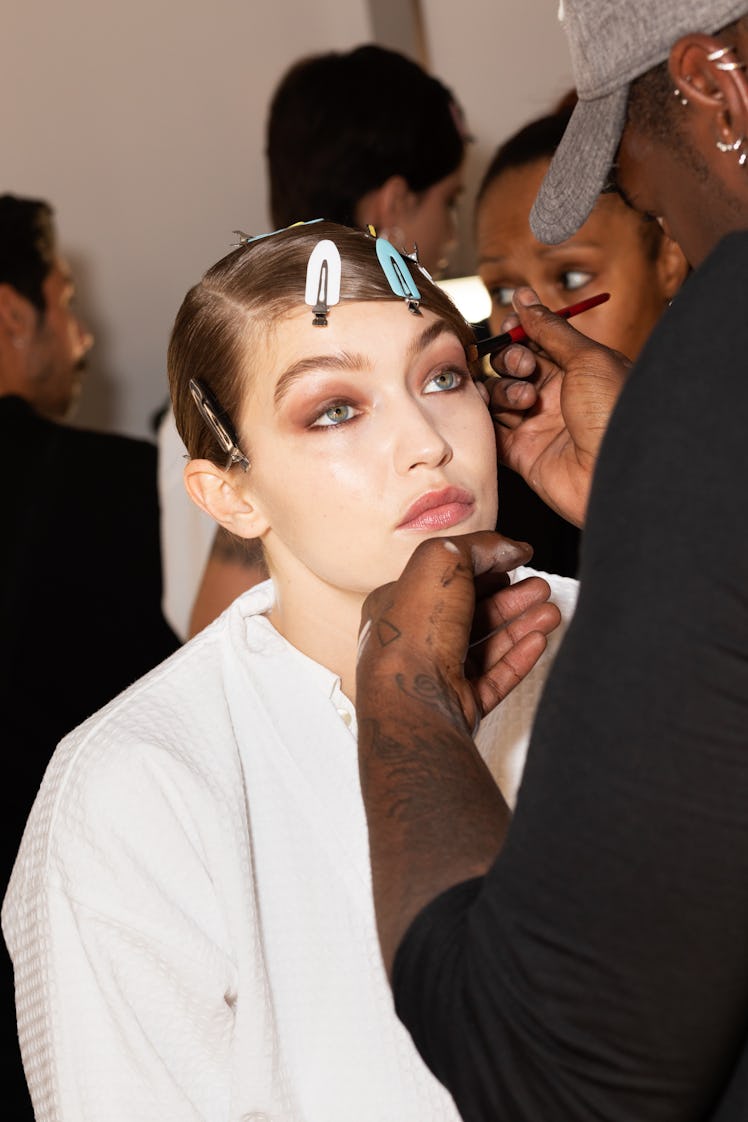 Gigi Hadid getting her makeup done before a fashion show