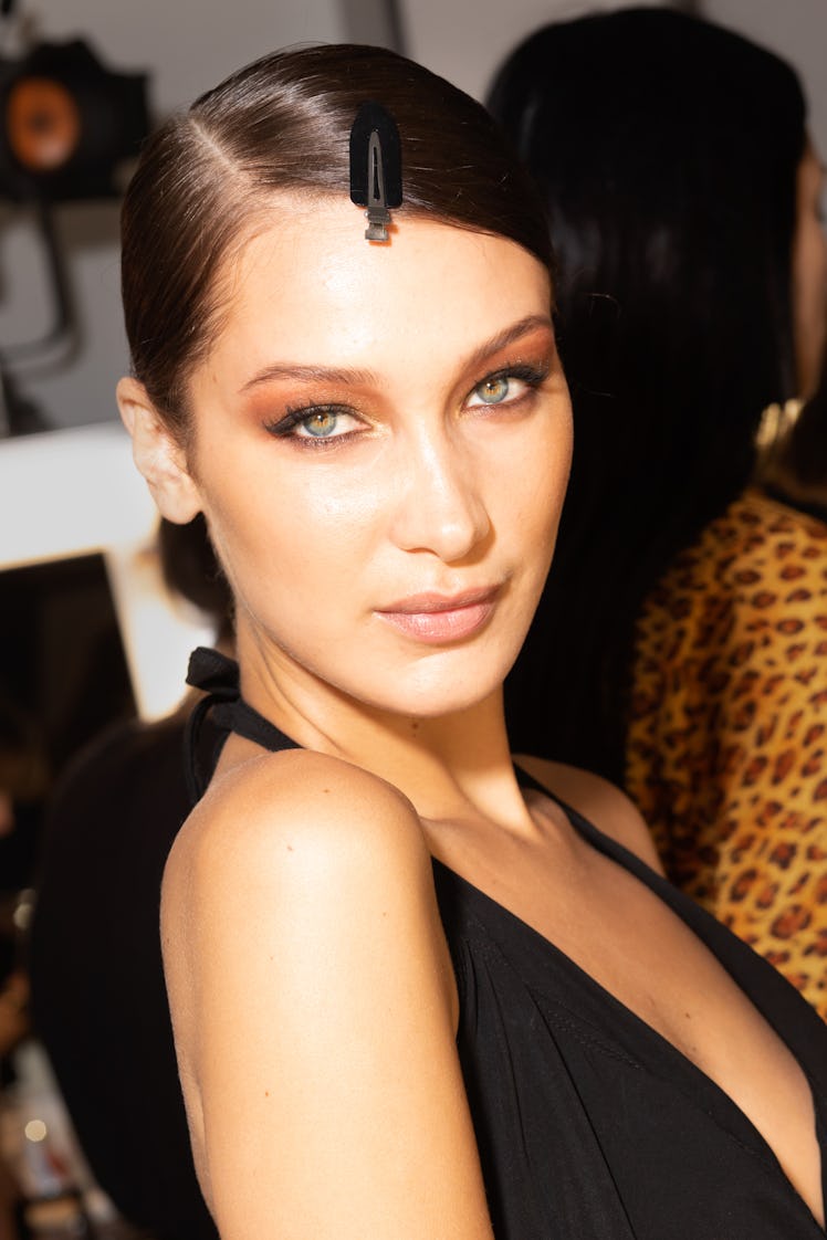 Bella Hadid wearing a black dress in backstage at the Tom Ford Fall fashion show